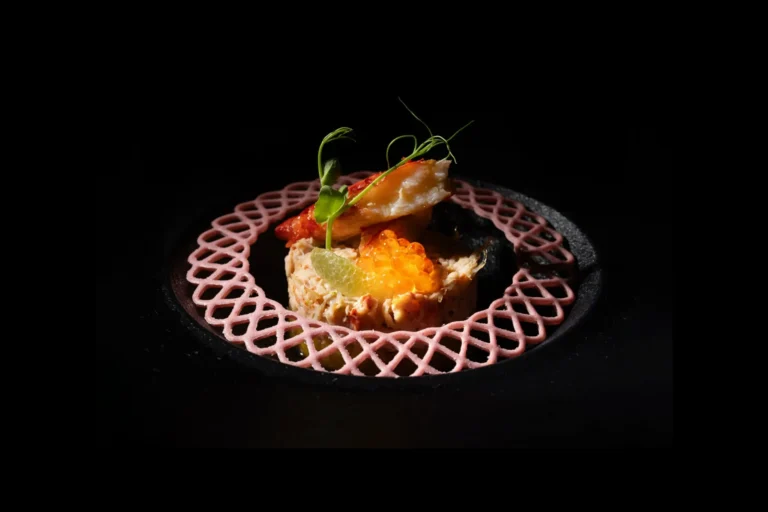 Tartar de salmón con huevas de pescado sobre fondo negro